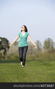 Teenage Girl Running Through Summer Meadow