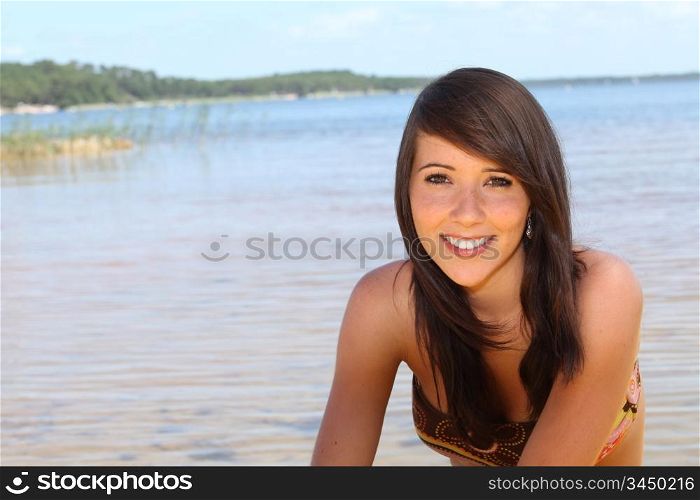 Teenage girl sat at the beach