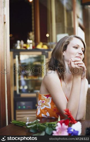 Teenage girl seated at a table in a restaurant