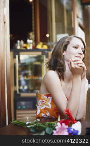 Teenage girl seated at a table in a restaurant