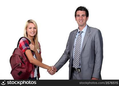 Teenage girl shaking teacher&acute;s hand
