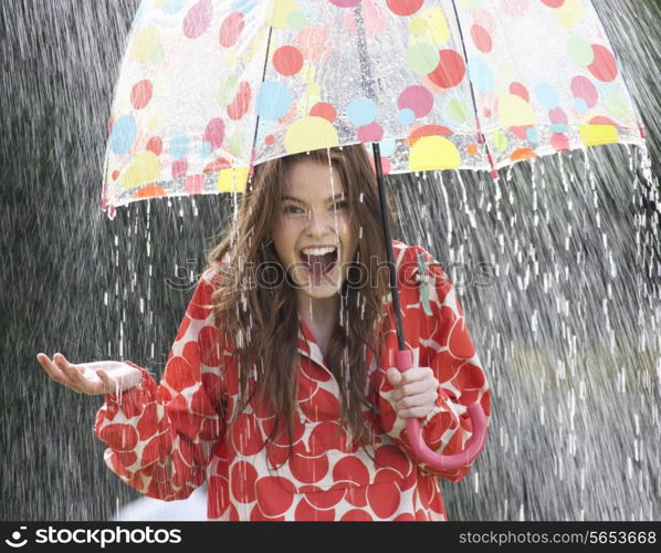 Teenage Girl Sheltering From Rain Beneath Umbrella