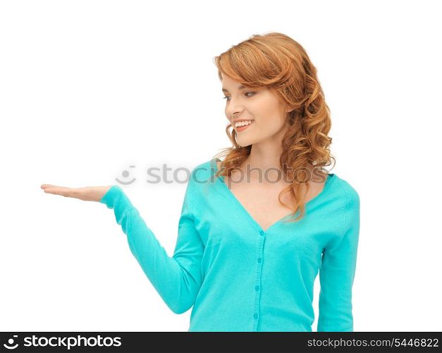teenage girl showing something on the palm of her hand
