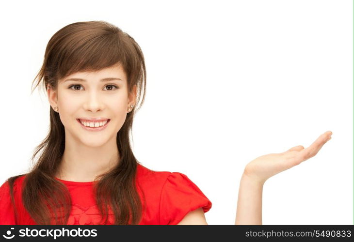 teenage girl showing something on the palm of her hand