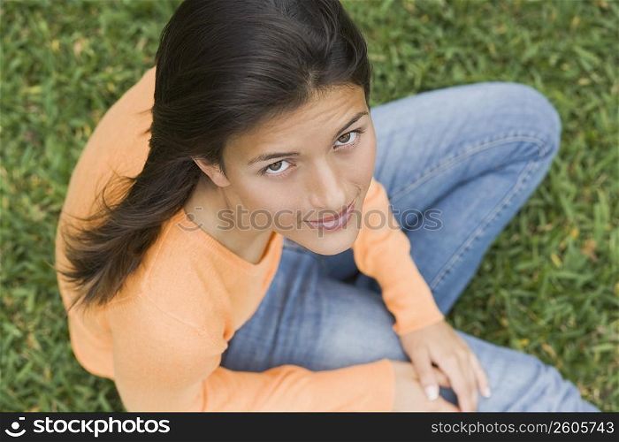 Teenage girl sitting in a park
