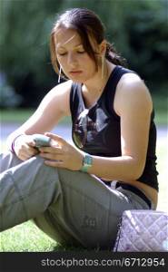 teenage girl sitting in park