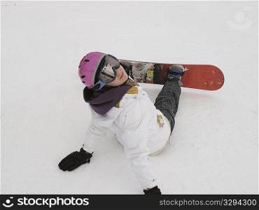Teenage girl sitting in the snow on a ski slope of Vail Colorado