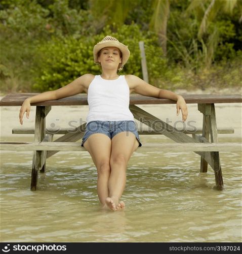 Teenage girl sitting on a bench