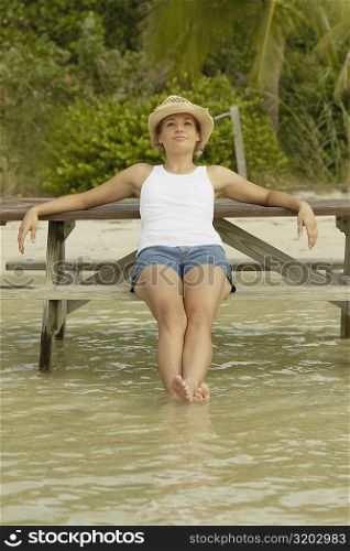 Teenage girl sitting on a bench