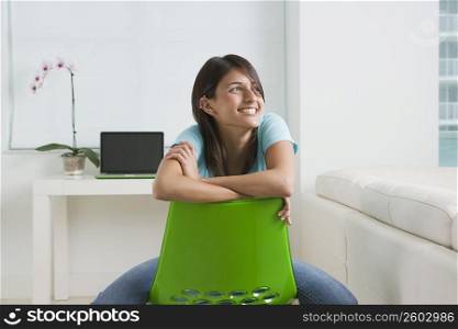Teenage girl sitting on a chair and smiling