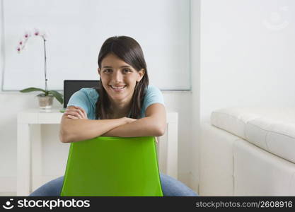 Teenage girl sitting on a chair and smiling