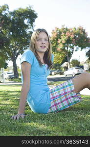 Teenage girl sitting on grass