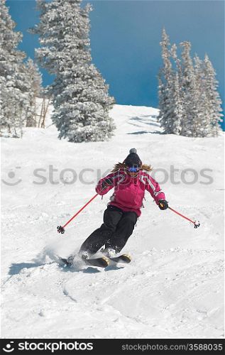 Teenage Girl Skiing Down a Slope