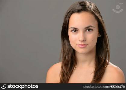 Teenage girl skin beauty portrait natural brunette on gray background