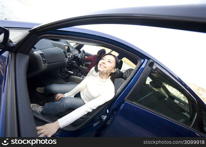 Teenage girl smiling getting out of a car