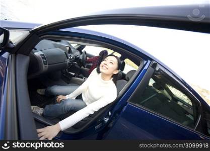 Teenage girl smiling getting out of a car