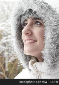 teenage girl smiling up while out in the snow