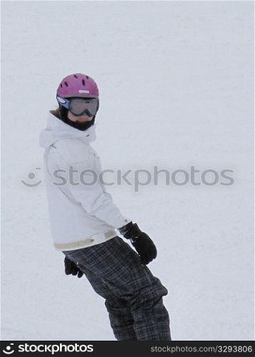 Teenage girl snowboarding on a ski slope in Vail, Colorado
