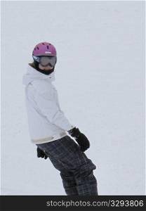 Teenage girl snowboarding on a ski slope in Vail, Colorado