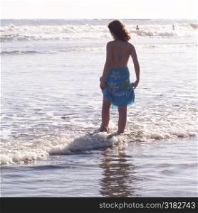 Teenage girl standing in the ocean
