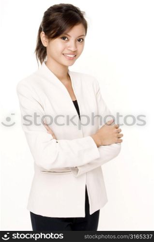 Teenage girl standing with her arms crossed and smiling