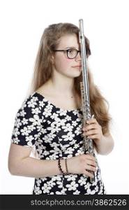 teenage girl stands pensive with flute against white background