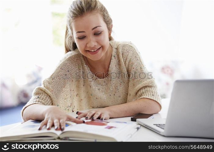 Teenage Girl Studying On Laptop At Home
