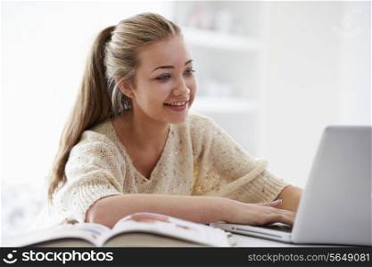 Teenage Girl Studying On Laptop At Home