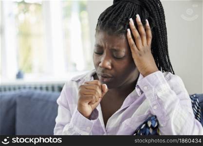 Teenage Girl Suffering With Cough At Home