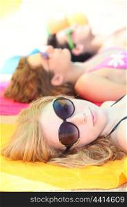 Teenage girl sunbathing with friends