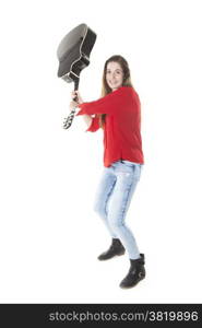 teenage girl swings guitar in studio with white background