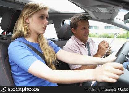 Teenage Girl Taking A Driving Lesson