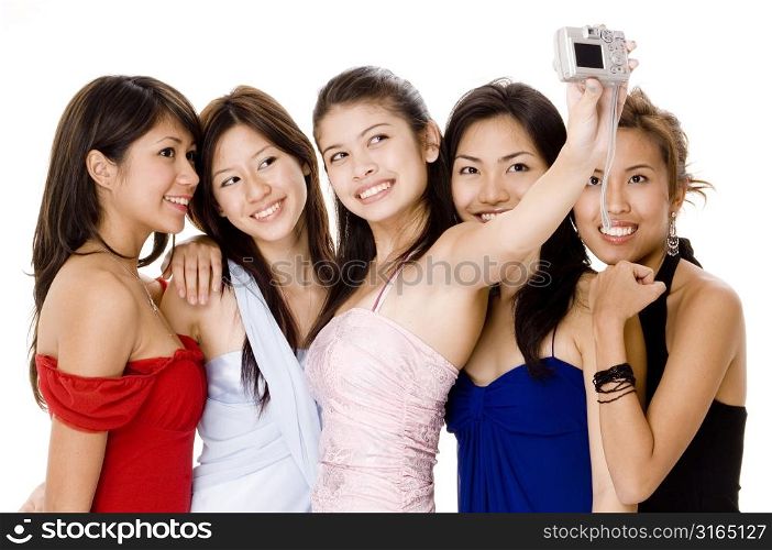 Teenage girl taking a picture of herself with her friends