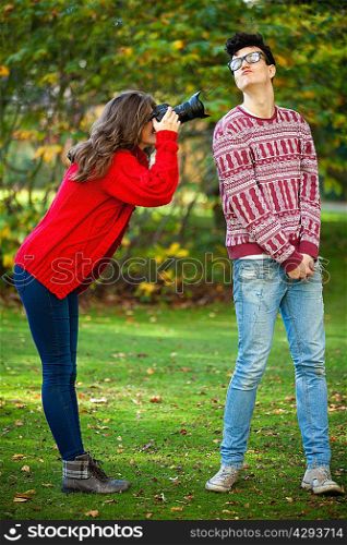 Teenage girl taking picture of boyfriend