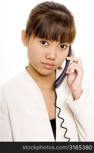 Teenage girl using a telephone