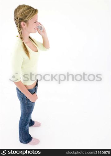 Teenage girl using cellular phone and smiling