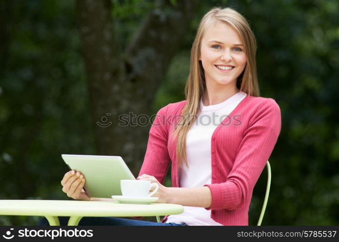 Teenage Girl Using Digital Tablet In Outdoor cafe