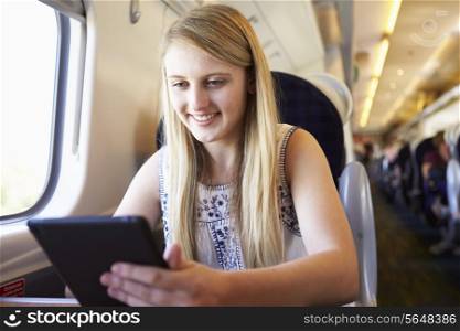 Teenage Girl Using Digital Tablet On Train Journey