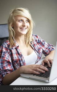 Teenage Girl Using Laptop At Home