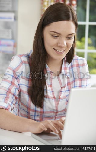 Teenage Girl Using Laptop At Home