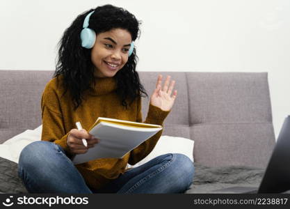 teenage girl using laptop headphones online school