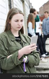 Teenage Girl Using Mobile Phone In Urban Setting