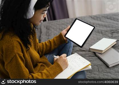 teenage girl using tablet online school