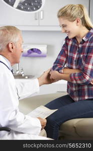 Teenage Girl Visits Doctor&#39;s Office With Elbow Pain