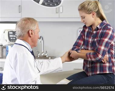 Teenage Girl Visits Doctor&#39;s Office With Elbow Pain