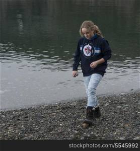 Teenage girl walking at the lakeside, Deception Pass State Park, Oak Harbor, Washington State, USA