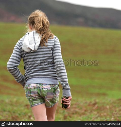 Teenage girl walking in a field, Sacred Valley, Cusco Region, Peru