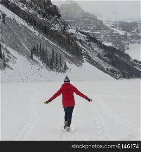 Teenage girl walking in snow, Banff National Park, Alberta, Canada