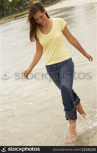 Teenage girl walking in water