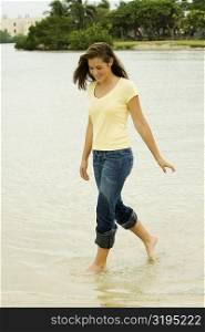 Teenage girl walking on the beach